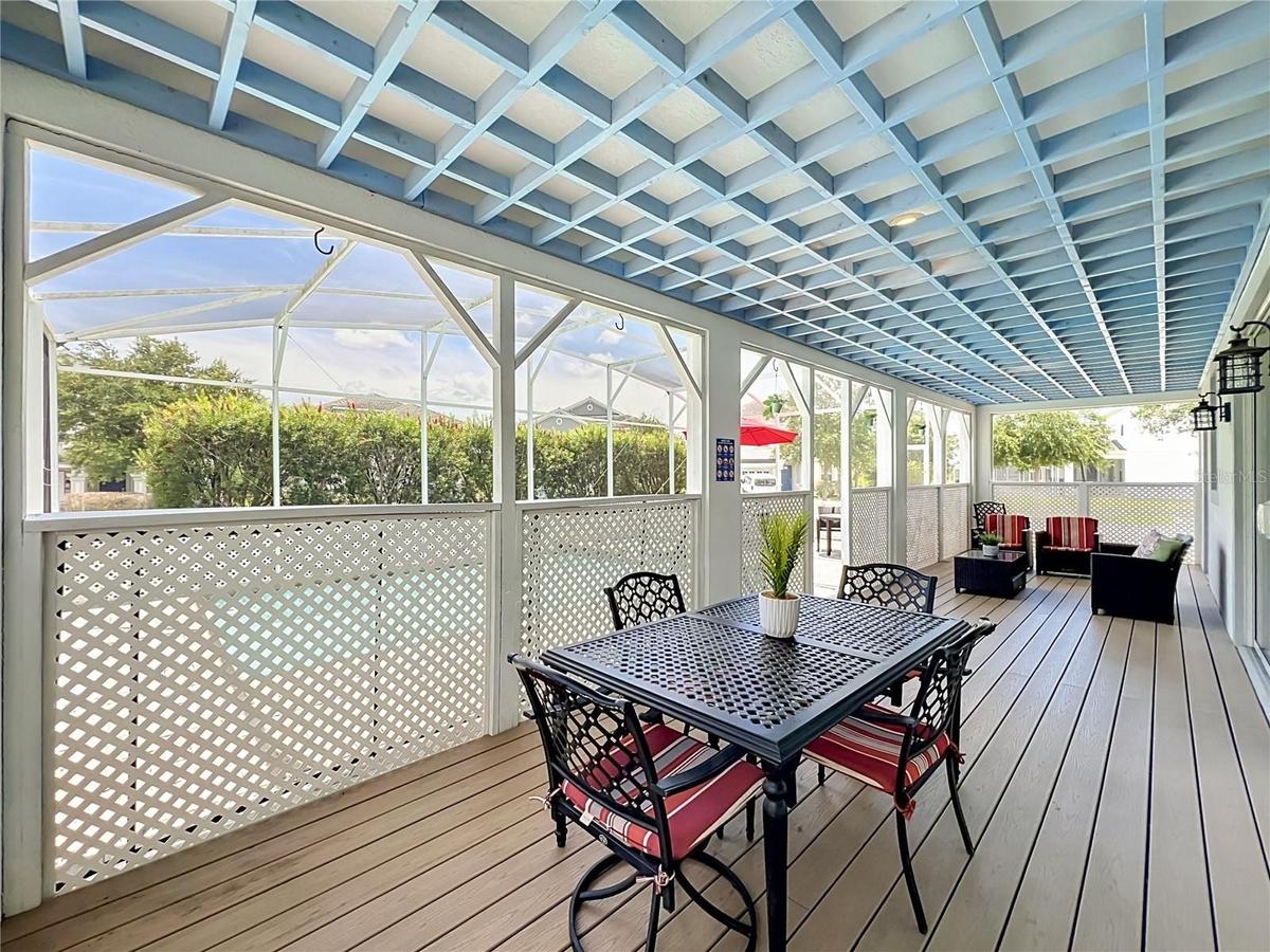 Covered lanai with upgraded wood flooring / wood ceiling accents.
