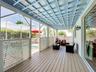 Covered lanai with upgraded wood flooring / wood ceiling accents.