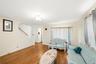 Living room featuring wood-finish flooring, a flush-mount ceiling light, and neutral wall tones