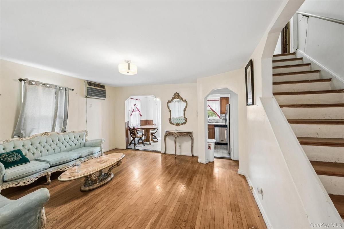 Living room featuring wood-finish flooring and a ceiling-mounted light fixture