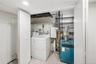 Dedicated utility area featuring a washer and dryer, tiled flooring, and recessed lighting