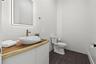 Half bathroom behind living area.
