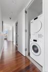 Dedicated laundry area featuring a stacked washer and dryer unit