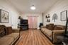 Spacious room featuring wood-finish flooring, crown molding, and recessed lighting