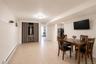 Versatile living area featuring light wood-finish flooring, recessed lighting, and a built-in wall shelf