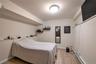 Bedroom featuring neutral wall colors, recessed ceiling lighting, and wood-look tile flooring