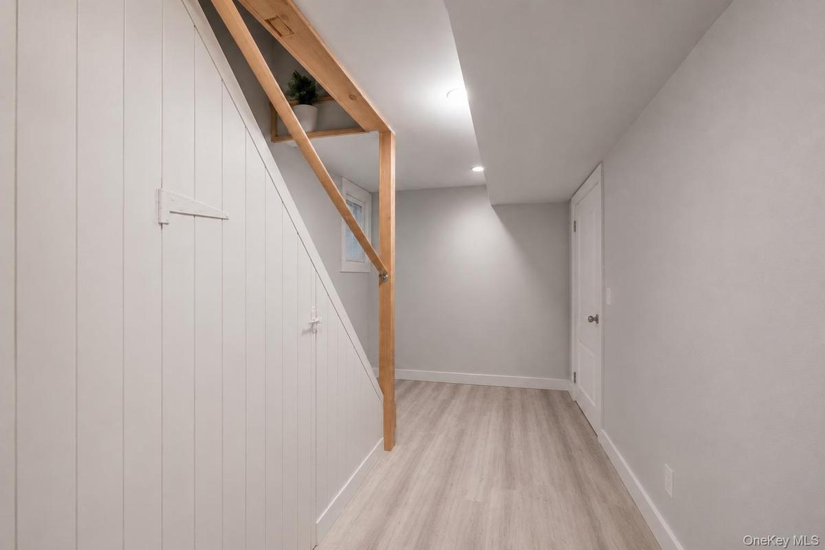 Light wood-finish flooring complements the neutral wall tones