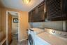 Washroom featuring a baseboard heating unit, cabinet space, and washer and dryer