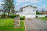 Split level home with asphalt driveway and an attached garage