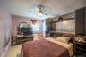 Bedroom featuring ceiling fan and baseboards