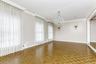 Spare room featuring baseboards, a chandelier, and ornamental molding