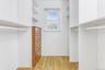 Walk in closet featuring light wood-style flooring