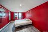 Bedroom with a textured ceiling and a baseboard radiator