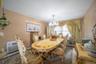 Dining area with carpet, a chandelier, and a baseboard heating unit