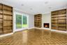 Unfurnished living room with built in shelves, a fireplace, baseboards, ornamental molding, and recessed lighting