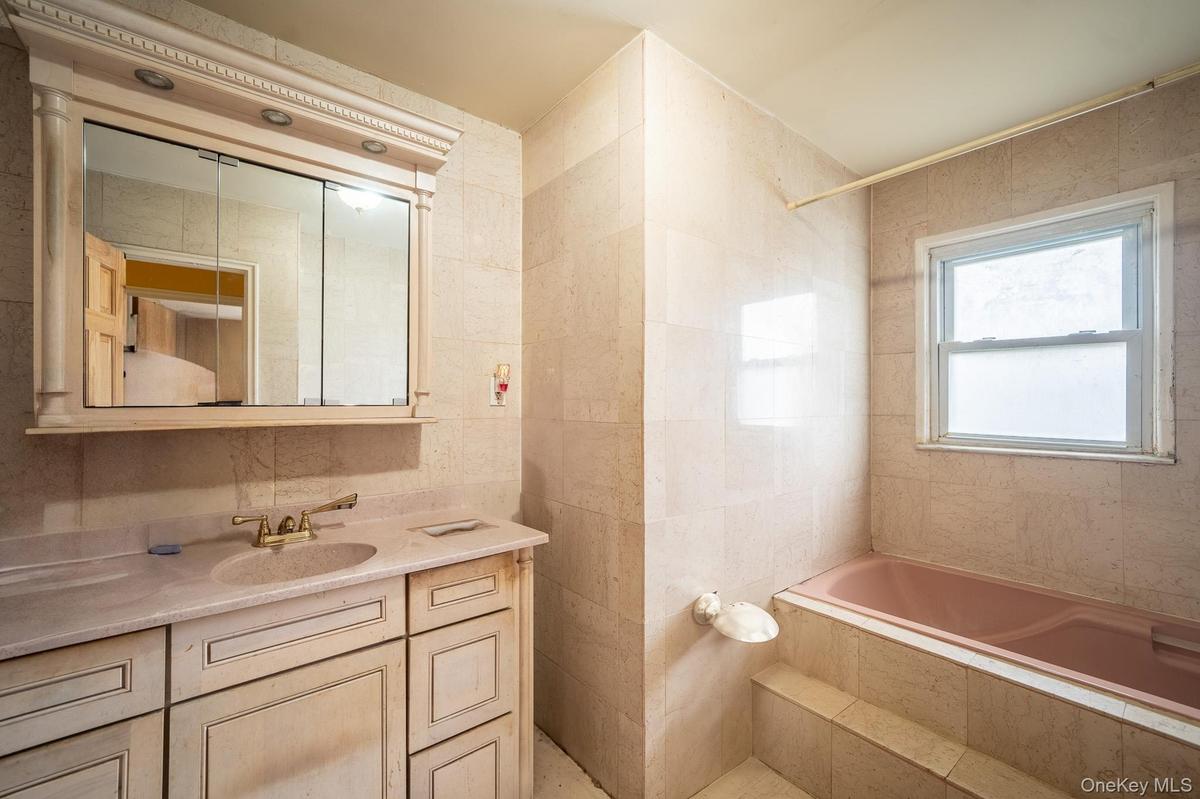 Bathroom with vanity and tile walls