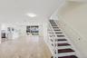 Tiled flooring with dark accent inlays, a white staircase with dark wood-finish treads, and recessed lighting