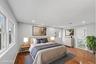 First Floor Primary Bedroom with wood-finish flooring, recessed lighting, and en-suite