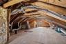 Spacious attic area offering storage and plywood flooring, and HVAC ductwork