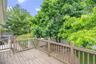 Expansive outdoor deck with wood-finish flooring and full railing system
