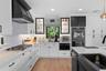 featuring custom cabinetry, quartz countertops, and ample storage