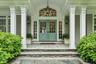 Double door entry with blue stone walkways and covered area with seating