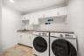Laundry room with separate utility sink and storage.