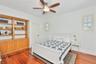 upstairs secondary bedroom with solid wood built in cabintry and shelving