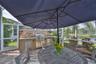 outdoor kitchen with sink, refrigerator, and gas grill