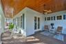 view of wrap around porch with side doors into study/library