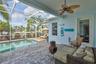 covered lanai with area to lounge and enjoy pool and canal views