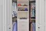 folding door master closet with built-ins