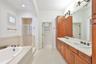 soaking tub, double sink vanity with generous countertop space