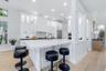 Kitchen has Oversized Island with Mitered Edge Quartz Countertops and New Appliances, Shaker Style Cabinets and Cabinet Lighting