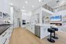 Kitchen has Oversized Island with Mitered Edge Quartz Countertops and New Appliances, Shaker Style Cabinets and Cabinet Lighting