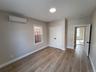 Spare room featuring an AC wall unit and light hardwood / wood-style flooring
