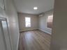 Spare room featuring an AC wall unit and light hardwood / wood-style floors