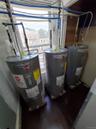 Utility room featuring electric water heater and water heater