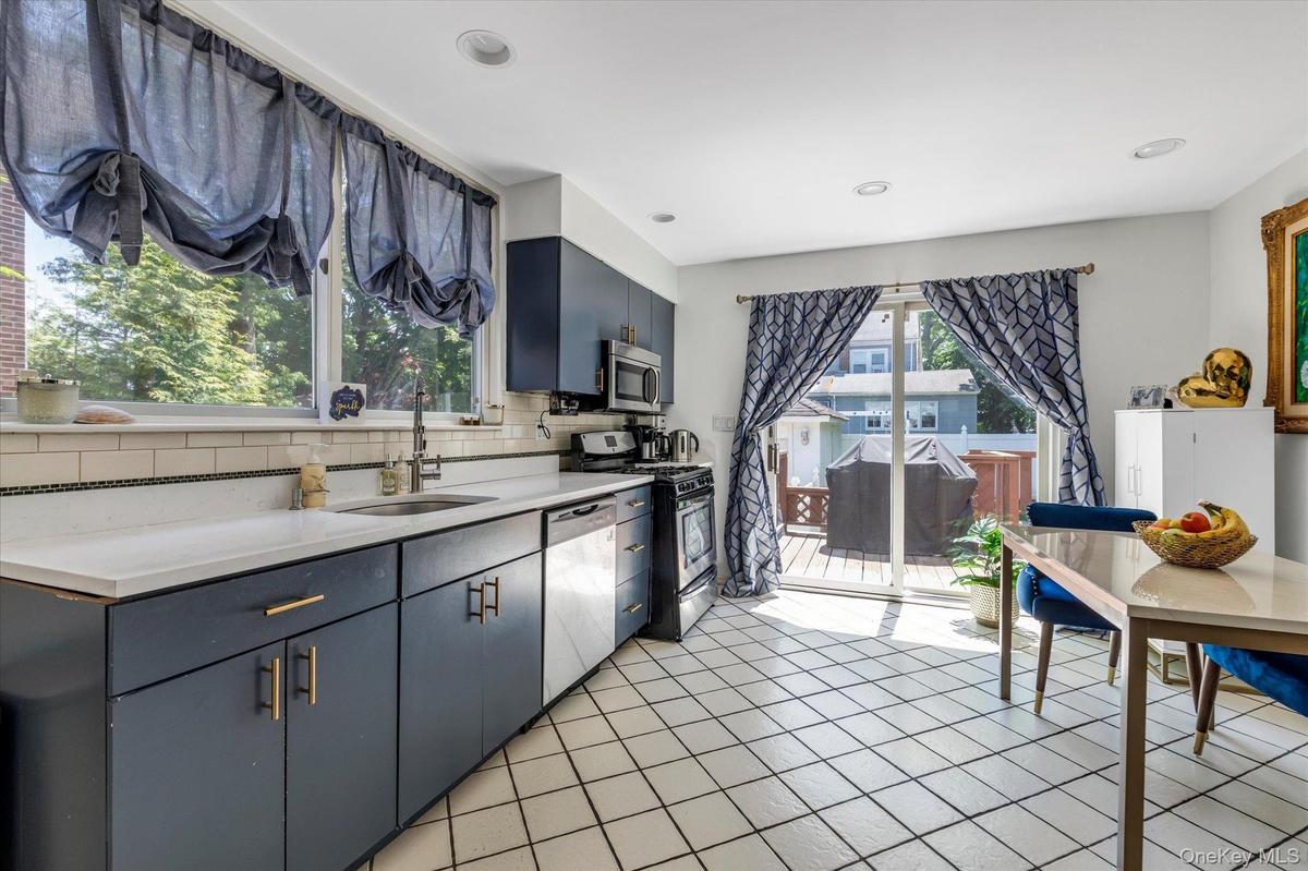 Eat in Kitchen with SS Appliances and Sliders to Deck