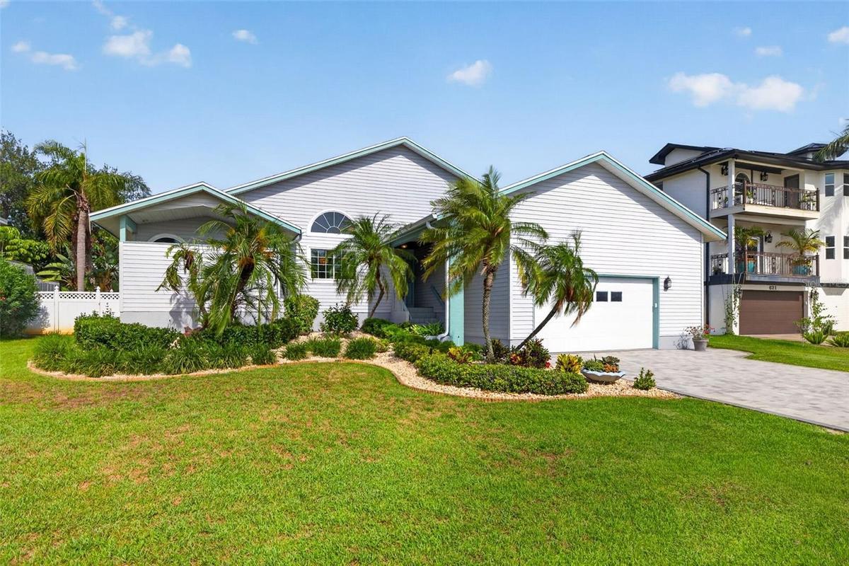 Nicely landscaped with freshly painted trim and new driveway pavers