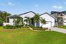 Nicely landscaped with freshly painted trim and new driveway pavers