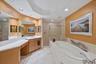 Primary ensuite bathroom - dual sinks, vanity space, separate shower stall