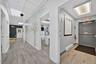 Hallway featuring wood-finish flooring, drop ceiling with recessed lighting, and white painted walls