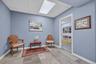 Tiled flooring in a light gray and tan palette, complemented by light blue walls