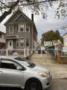 View of front of home featuring a fenced front yard, a gate, and a chimney