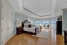 Bedroom with light wood-type flooring, recessed lighting, ornamental molding, and a tray ceiling