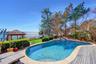 View of swimming pool with fence, a water view, and a fenced in pool