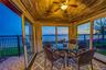 Sunroom / solarium with a water view, lofted ceiling, and wooden ceiling