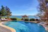 View of swimming pool featuring a fenced in pool, a gazebo, and fence
