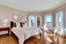 Bedroom featuring recessed lighting, wood finished floors, a water view, and crown molding